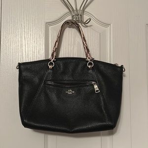 Black Coach bag with patterned handle.